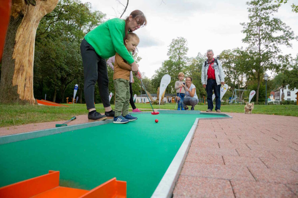 Familie beim Minigolfen