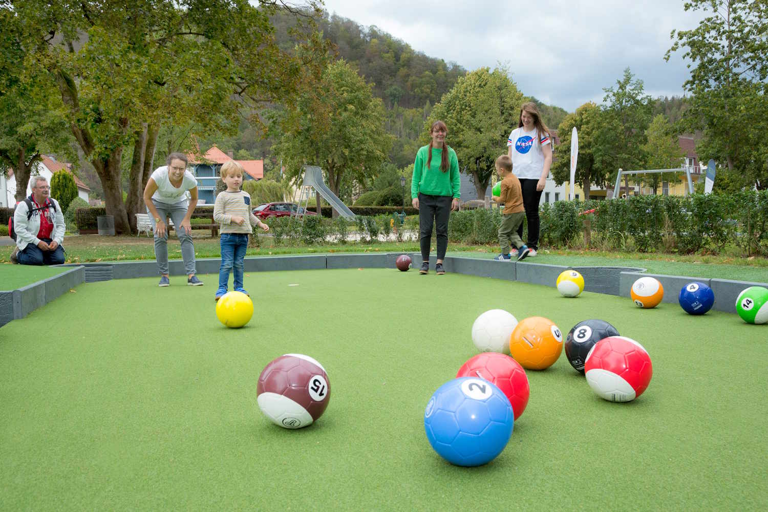 Familie spielt Fußball Billard im Kurpark.